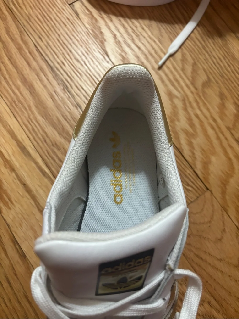 adidas Women's White Sneakers with Gold Stripe Accents